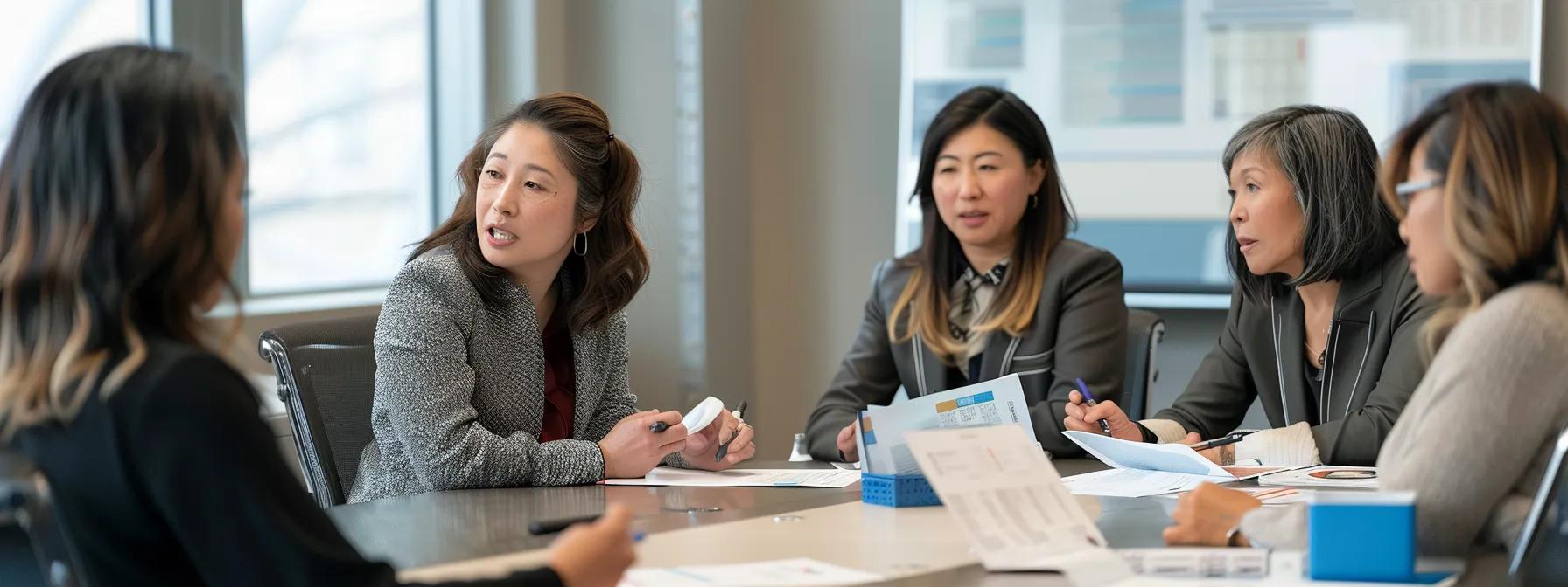 Group of professional women engaged in a financial counseling discussion around a table, analyzing documents and sharing insights on foreclosure prevention strategies.