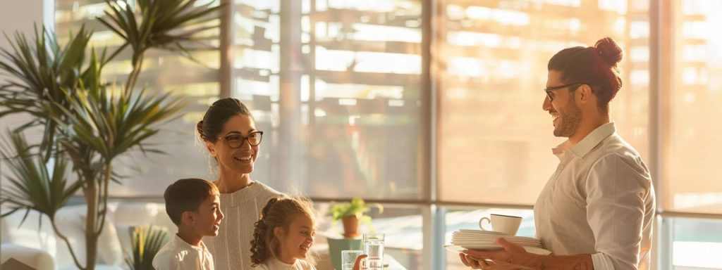 Family enjoying a bright, modern kitchen with a man serving food to a woman and two children, emphasizing a warm, family-oriented atmosphere.