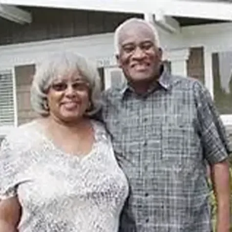 Phebie and bobby standing in front of a house that was sold for cash to Amran Property Investments